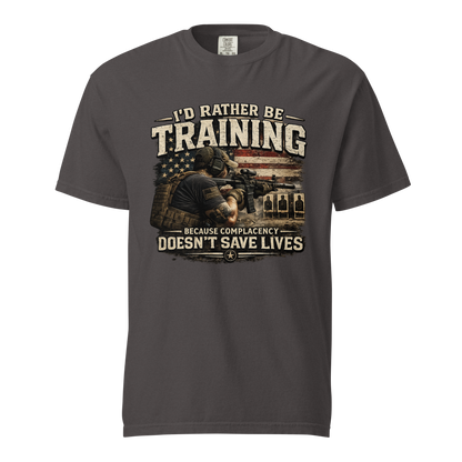 I'd Rather Be Training graphic shirt featuring a shooter on the range with the message Because Complacency Doesn't Save Lives for firearms training and shooting sports enthusiasts.